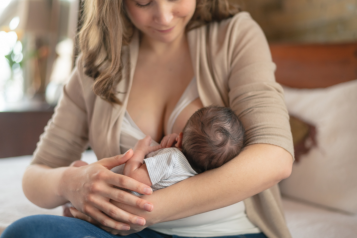 a mother breastfeeding small baby