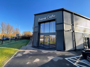 Image of office building with glass fronted entrance. Sign above the door reads, 'Business Centre'.