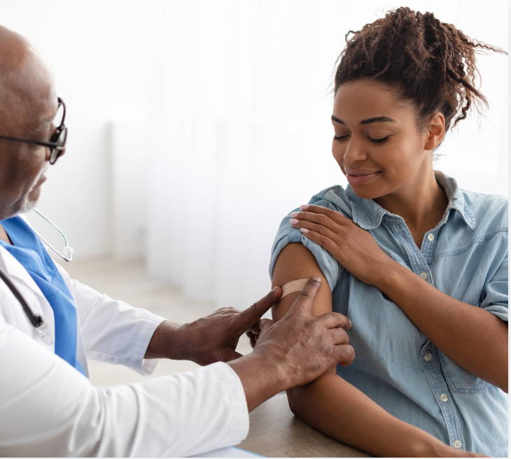 women gets vaccinated by a health care professional. 