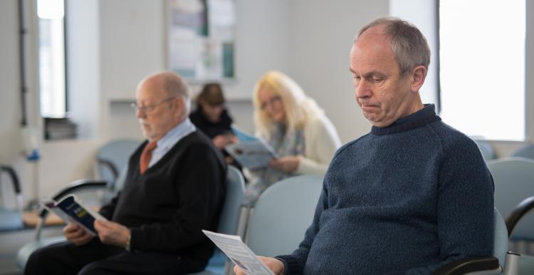 people sitting in a GP waiting room 