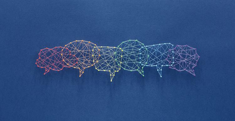 Different coloured speech bubbles over lap each other. 