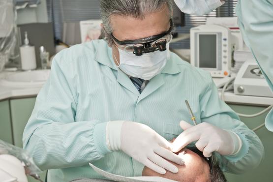dentist examining patient’s mouth
