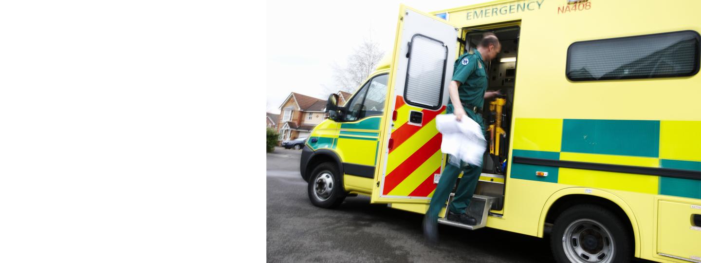 Paramedic climbing into an ambulance