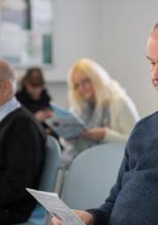 people sitting in a GP waiting room 