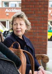 Two women sitting outside a hospital